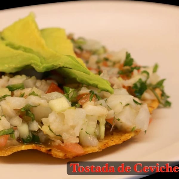 La Parrilla Taqueria's Tostada de Ceviche, a crispy tortilla topped with fresh ceviche and avocado slices.
